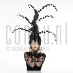 25-02-2004 Trudy Labij at studio in Amsterdam, on behalf of poster -La Bij, Ik voel mij goed-, by order of impresariaat Jacques Senf, February 25, 2004 

[keywords]Posed, Eyecontact, Headgear[/keywords]